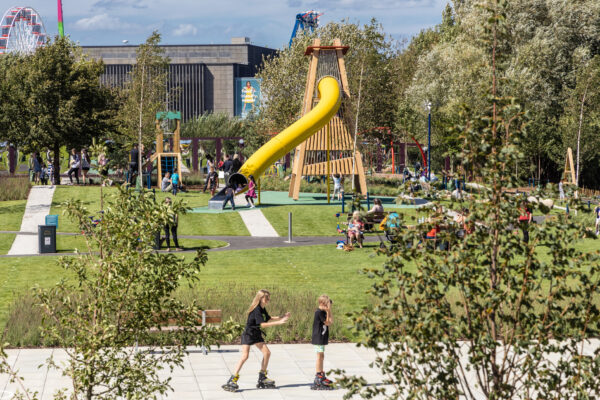 Familes enjoying a sunny afternoon in Exploratory Park, Brent Cross South