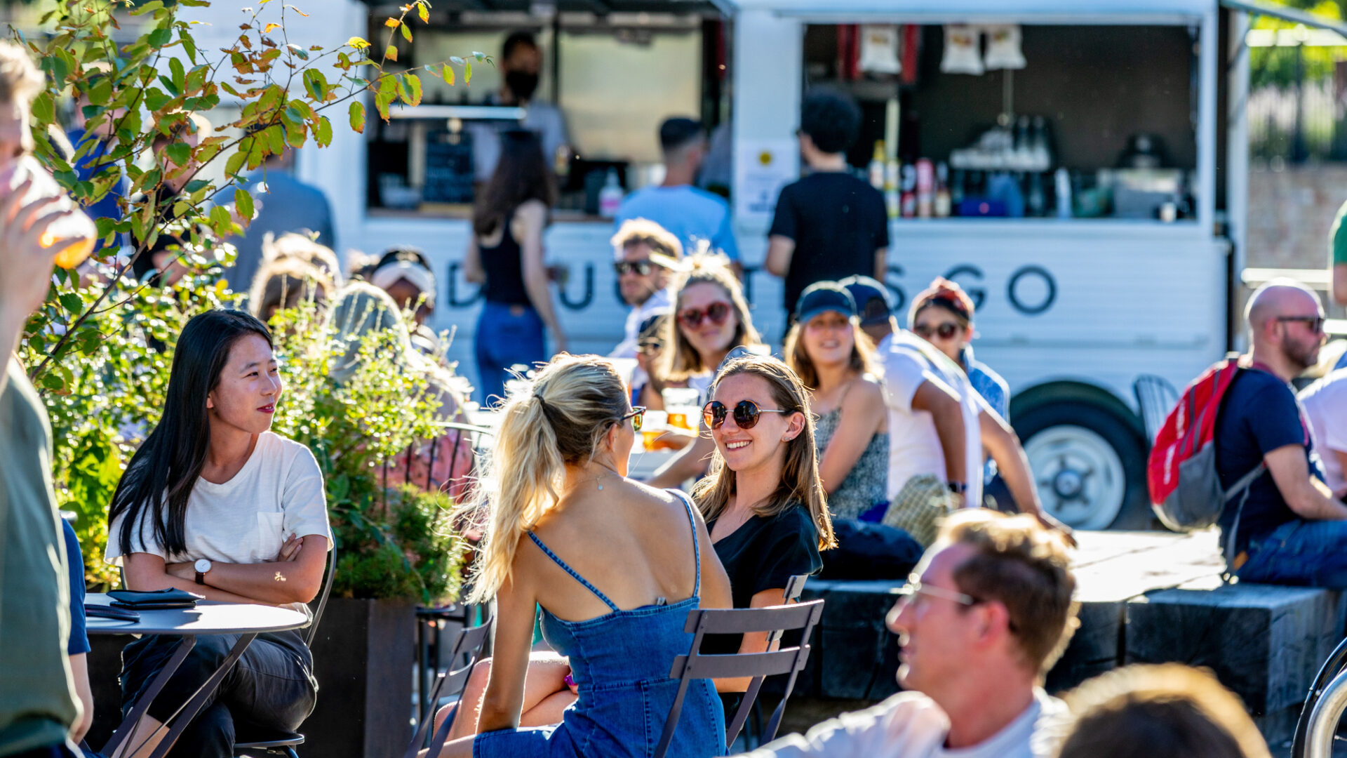 People enjoying the sunshine at Sons & Daughters, Granary Square, King's Cross