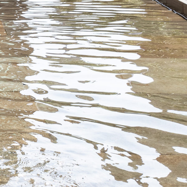 Young girl enjoying the water during hot weather in Pancras Square, King's Cross - parental permission given.
